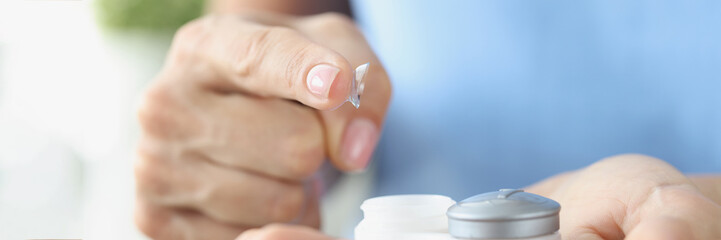 Canvas Print - Fingertip contact lenses and storage box closeup