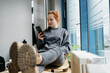 © contrastwerkstatt - young redhead woman with cell phone takes break in office