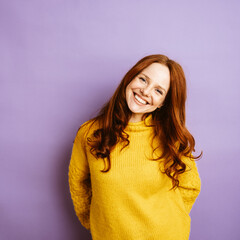 young redhead woman laughing at camera