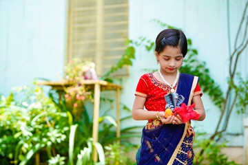 Wall Mural - Cute indian little girl celebrating lord ganesha festival.