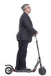 © ASDF - man with an electric scooter pointing at a white screen
