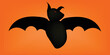black bat with red eye in orange background halloween flying bat ghost