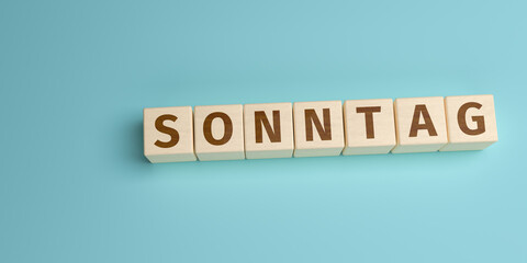 Wall Mural - The German word Sonntag (Sunday) built from letters on wooden cubes. High angle view with copy space