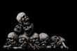 Awesome pile of skull human and bone on wooden, black cloth background, concept of scary crime scene of horror or thriller movies,Halloween theme, Still Life style, selective focus,