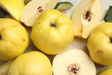 Fototapeta  - Fresh ripe organic quinces on light table, closeup