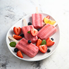 Wall Mural - Traditional homemade berry popsicles on a plate