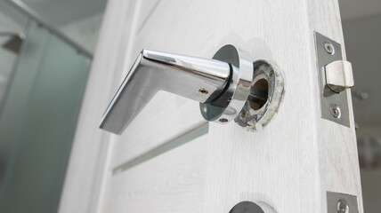 Broken doorknob in interior door. Poor quality door hardware, close-up