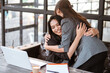 © Odua Images - beautiful female worker greeting and hug her partner while meeting at the office