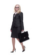 © ASDF - smiling business woman with a leather briefcase striding forward