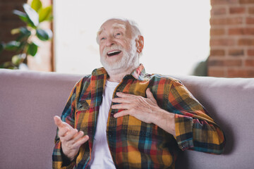 Poster - Photo of funny funky cheerful man pensioner wear sitting sofa laughing smiling indoors house room