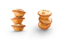 A Collection Of Christmas Mince Pies Staked, Piled Up Isolated Against A Flat Background.