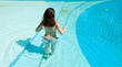 girl with sexy ass standing in summer swimming pool water on vacation with copy space