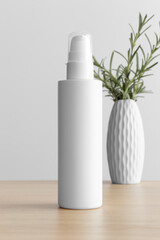 Wall Mural - White cosmetic lotion bottle mockup with a rosemary on the wooden table.