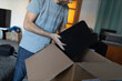 © primipil - Adult man small business owner packing order box package shipping to customer. Entrepreneur online shopping packaging speaker in box for delivery at home.