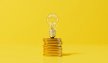 Rising Energy Cost Concept. Light Bulb On Top Of A Stack Of Gold Coins. 3D Rendering