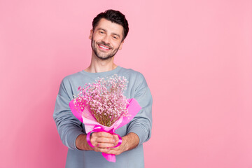 Wall Mural - Portrait of positive person arms hold fresh flowers bouquet isolated on pink color background