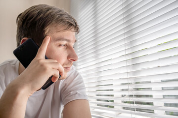 Wall Mural - Sad Young Man with a Phone