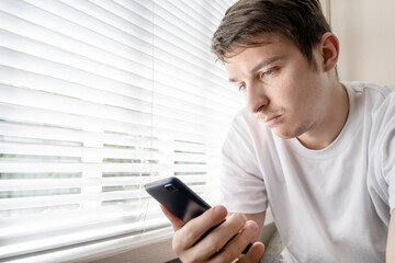 Canvas Print - Sad Young Man with a Phone