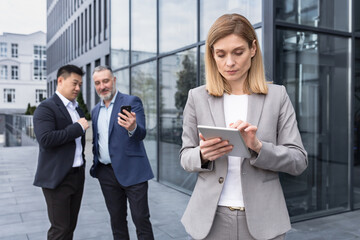 harassment and stalking bullying in the office, business people colleagues men making fun of a woman, business team standing outside the office building gossiping about the boss's woman men