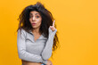 © SHOTPRIME STUDIO - Young insighted smart proactive fun curly african american woman 20s wearing casual gray shirt holding index finger up with great new idea isolated on pink color background. People lifestyle concept.