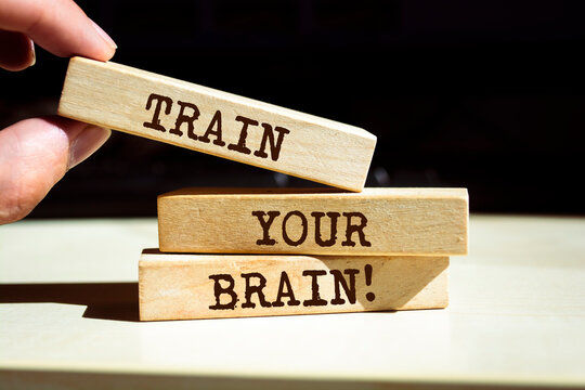 Wooden blocks with words 'Train Your Brain'.