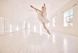 Ballet dance, jump and studio dancer dancing beautiful, elegant or classic performance in theater room. Stage artist, professional theatre ballerina and creative woman with energy moving with beauty