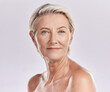 Beauty, skincare and wellness with a senior woman in studio isolated against a grey background. Face portrait of health, skin care and natural body with a female looking happy, perfect and confident