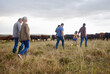© Nina Lawrenson/peopleimages.com - Family together, cattle field and business with people you love. Countryside farmer parents walking in meadow with children to bond. Relationship with kids and sharing ranch for next generation.