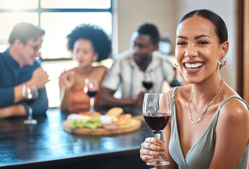 Social, happy and wine of a woman with a glass of alcohol at a dinner table with friends in a restaurant. Young female with smile in luxury fun dining with people at a celebration or event indoors.