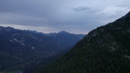 Wall Mural - Flying over pine forest covered mountains in Okanogan-Wenatchee National Forest, Washington.