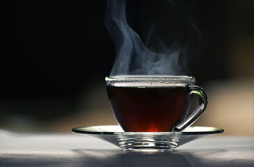 photo of hot black coffee cup on dark background