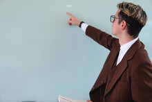 Teacher Looking At The Whiteboard. Blond Caucasian Elegant Man Dressed As A Teacher. Elegant Man Giving Class. High Quality Photo