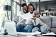 © Nicholas Felix/peopleimages.com - Smiling, happy and hugging couple enjoying, embracing and loving remote work together at home. Young romantic partners working online and celebrating successful news or job success letter on a sofa