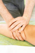 close up of a person receiving a massage on knee