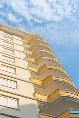 Canvas Print - Low angle view of an apartment building with balconies.