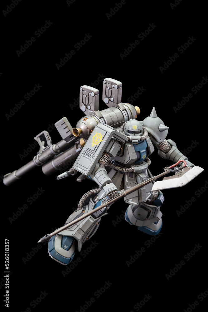plastic model of gundam from the gundam series of animated tv shows. the model is posed on a black background and is manufactured by bandai