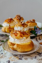 Canvas Print - Closeup shot of Eclairs with cream bun and floral decoration