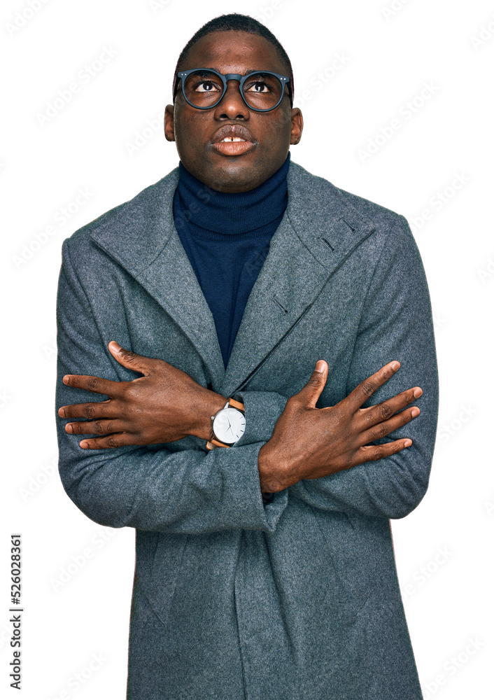 Young african american man wearing business clothes and glasses shaking and freezing for winter cold with sad and shock expression on face