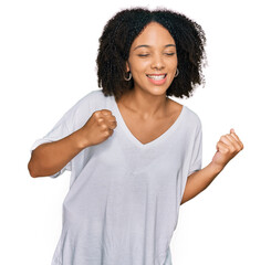 Wall Mural - Young african american girl wearing casual clothes excited for success with arms raised and eyes closed celebrating victory smiling. winner concept.