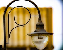 Closeup Of An Old Lamp With A Curving Metal Post