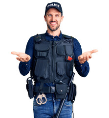 Canvas Print - Young handsome man wearing police uniform smiling cheerful offering hands giving assistance and acceptance.