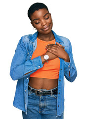 Wall Mural - Young african american woman wearing casual clothes smiling with hands on chest with closed eyes and grateful gesture on face. health concept.