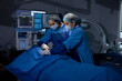 © G-images - Two female surgeons performing surgery at hospital operating room