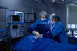 © G-images - Two doctor surgeons operating patient at hospital