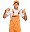 © Krakenimages.com - Young handsome african american man wearing handyman uniform smiling cheerful showing and pointing with fingers teeth and mouth. dental health concept.
