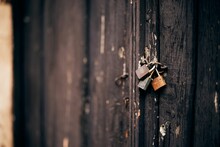 Closeup Of Locked Locks On Old Wooden Door