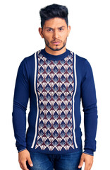 Poster - handsome latin american young man wearing casual winter sweater skeptic and nervous, frowning upset 