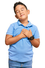 Poster - Little boy hispanic kid wearing casual clothes smiling with hands on chest with closed eyes and grateful gesture on face. health concept.