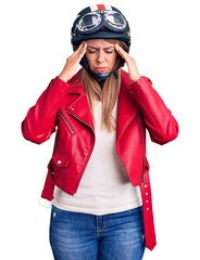 Wall Mural - Young beautiful woman wearing motorcycle helmet suffering from headache desperate and stressed because pain and migraine. hands on head.