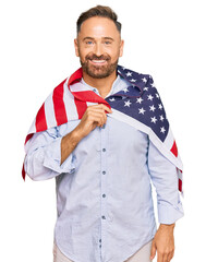 Sticker - Handsome middle age man holding united states flag looking positive and happy standing and smiling with a confident smile showing teeth